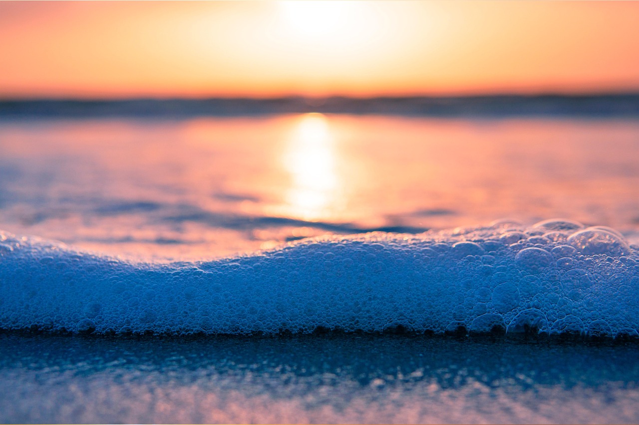 bubbles sea foam spume beach sunset ocean sea seashore shore sand ebb nature waves coast coastline dusk sunrise seaside tropical 5671365.jpg