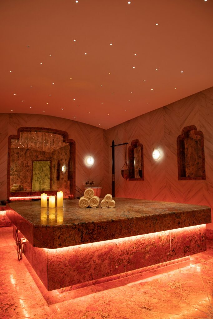 Exquisite Turkish bath in Delhi with warm lighting, towels, and candles.
